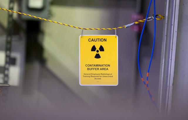 A sign warns of radioactive contamination during a tour with US Secretary of Energy Chris Wright at the Idaho National Laboratory in an area west of Idaho Falls, Idaho, on June 25, 2026. Several next-generation small nuclear reactors, widely seen as the future of the sector, are now operational or close to becoming so in the United States -- a major milestone made possible by an influx of private capital and support from the American government. The milestone was put on display in the middle of the Idaho dessert where a cluster of drab hangars might otherwise go unnoticed. (Photo by Josh Edelson / AFP)