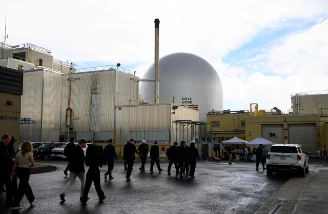 People walk along with US Secretary of Energy Chris Wright as he tours the Idaho National Laboratory in an area west of Idaho Falls, Idaho, on June 25, 2026. Wright visited various sites where companies have been racing to build small modular nuclear reactors in what has been heralded as Americas nuclear renaissance. Several next-generation small nuclear reactors, widely seen as the future of the sector, are now operational or close to becoming so in the United States -- a major milestone made possible by an influx of private capital and support from the American government. The milestone was put on display in the middle of the Idaho dessert where a cluster of drab hangars might otherwise go unnoticed. (Photo by Josh Edelson / AFP)
