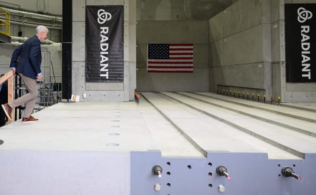 US Secretary of Energy Chris Wright walks along a concrete area that will house a nuclear reactor at the Idaho National Laboratory in an area west of Idaho Falls, Idaho, on June 25, 2026. Wright visited various sites where companies have been racing to build small modular nuclear reactors in what has been heralded as Americas nuclear renaissance. Several next-generation small nuclear reactors, widely seen as the future of the sector, are now operational or close to becoming so in the United States -- a major milestone made possible by an influx of private capital and support from the American government. The milestone was put on display in the middle of the Idaho dessert where a cluster of drab hangars might otherwise go unnoticed. (Photo by Josh Edelson / AFP)