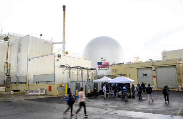 People walk along with US Secretary of Energy Chris Wright as he tours the Idaho National Laboratory in an area west of Idaho Falls, Idaho, on June 25, 2026. Wright visited various sites where companies have been racing to build small modular nuclear reactors in what has been heralded as Americas nuclear renaissance. Several next-generation small nuclear reactors, widely seen as the future of the sector, are now operational or close to becoming so in the United States -- a major milestone made possible by an influx of private capital and support from the American government. The milestone was put on display in the middle of the Idaho dessert where a cluster of drab hangars might otherwise go unnoticed. (Photo by Josh Edelson / AFP)