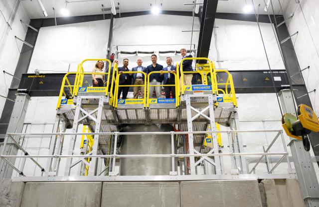 US Secretary of Energy Chris Wright (C) stands atop a nuclear reactor at Aalo Atomics facility as he tours the Idaho National Laboratory in an area west of Idaho Falls, Idaho, on June 25, 2026. Wright visited various sites where companies have been racing to build small modular nuclear reactors in what has been heralded as Americas nuclear renaissance. Several next-generation small nuclear reactors, widely seen as the future of the sector, are now operational or close to becoming so in the United States -- a major milestone made possible by an influx of private capital and support from the American government. The milestone was put on display in the middle of the Idaho dessert where a cluster of drab hangars might otherwise go unnoticed. (Photo by Josh Edelson / AFP)