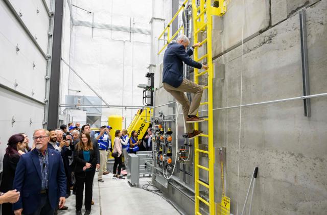 US Secretary of Energy Chris Wright climbs atop a nuclear reactor at Aalo Atomics facility during a tour of the Idaho National Laboratory in an area west of Idaho Falls, Idaho, on June 25, 2026. Wright visited various sites where companies have been racing to build small modular nuclear reactors in what has been heralded as Americas nuclear renaissance. Several next-generation small nuclear reactors, widely seen as the future of the sector, are now operational or close to becoming so in the United States -- a major milestone made possible by an influx of private capital and support from the American government. The milestone was put on display in the middle of the Idaho dessert where a cluster of drab hangars might otherwise go unnoticed. (Photo by Josh Edelson / AFP)