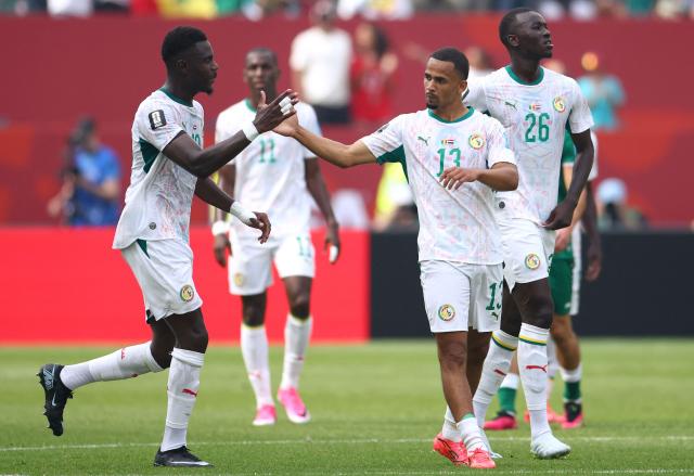 Senegal's forward #13 Iliman Ndiaye celebrates with teammate Senegal's defender #19 Moussa Niakhate after scoring his team's fifth goal during the 2026 World Cup Group I football match between Senegal and Iraq at the Toronto Stadium in Toronto on June 26, 2026.  (Photo by Cole Burston / AFP)