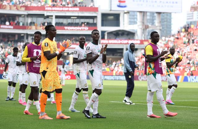Senegal's goalkeeper #23 Mory Diaw and defender #19 Moussa Niakhate greet fans after winning the 2026 World Cup Group I football match between Senegal and Iraq at the Toronto Stadium in Toronto on June 26, 2026.  (Photo by Cole Burston / AFP)