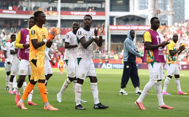Senegal's goalkeeper #23 Mory Diaw and defender #19 Moussa Niakhate greet fans after winning the 2026 World Cup Group I football match between Senegal and Iraq at the Toronto Stadium in Toronto on June 26, 2026.  (Photo by Cole Burston / AFP)