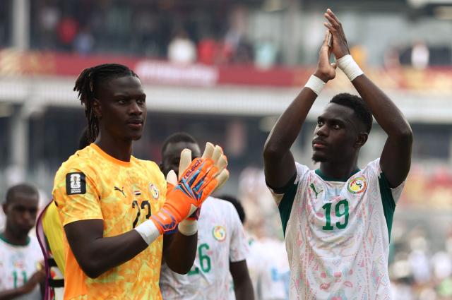 Senegal's goalkeeper #23 Mory Diaw and defender #19 Moussa Niakhate greet fans after winning the 2026 World Cup Group I football match between Senegal and Iraq at the Toronto Stadium in Toronto on June 26, 2026.  (Photo by Cole Burston / AFP)