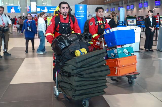 EDITORS NOTE: Graphic content / Members of the USAR team of the Peruvian Volunteer Firefighters General Corps prepare to depart from Jorge Chavez International Airport in Lima, Peru, on June 26, 2026, en route to Venezuela to support search and rescue operations following deadly earthquakes. The death toll from two powerful earthquakes that devastated Venezuela earlier this week rose to 920 on June 26, National Assembly President Jorge Rodriguez said. (Photo by Veronica CALDERON / AFP)