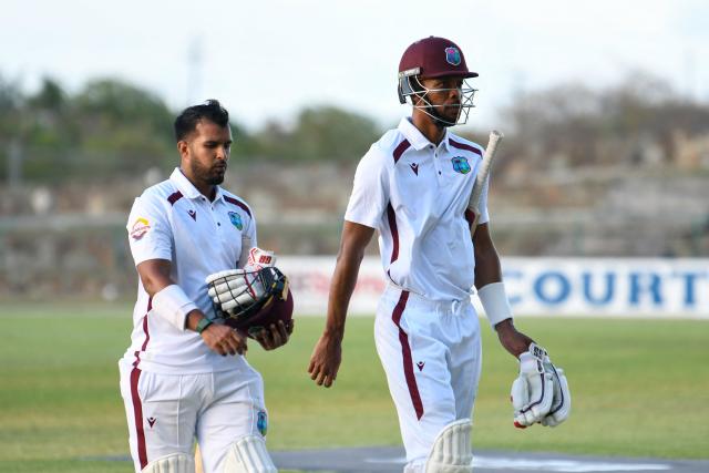 Amir Jangoo (R) and Roston Chase (L) of West Indies walk off the field at the end of the 2nd day of the 1st Test between Sri Lanka and West Indies at Vivian Richards Cricket Stadium in North Sound, Antigua and Barbuda, on June 26, 2026. (Photo by Randy Brooks / AFP)