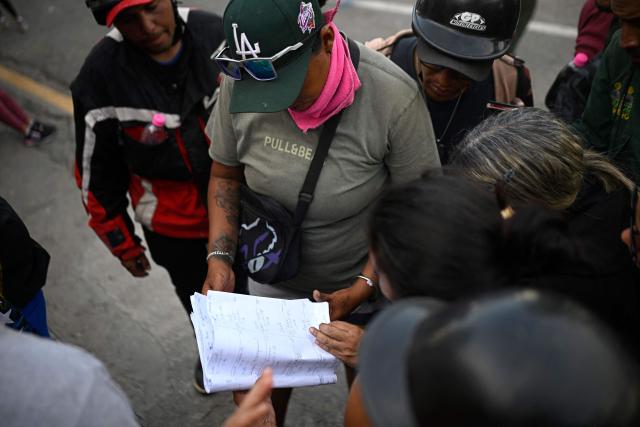 Relatives check a list of injured patients outside the Pariata Hospital in La Guaira state, Venezuela, on June 26, 2026, following deadly earthquakes. The death toll from two powerful earthquakes that devastated Venezuela earlier this week rose to 920 on June 26, National Assembly President Jorge Rodriguez said. (Photo by Federico PARRA / AFP)