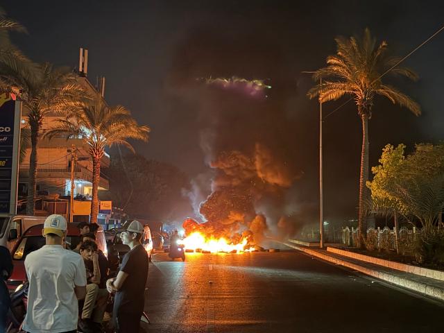 Hezbollah supporters block the old airport road in the southern suburbs of Beirut, with burning tires to protest against the trilateral agreement that was signed between the US, Israel and Lebanon on June 27, 2026. (Photo by Ibrahim AMRO / AFP)