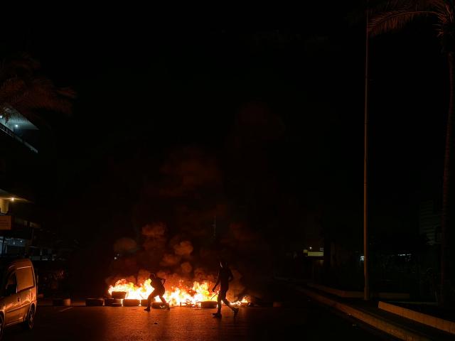 Hezbollah supporters block the old airport road in the southern suburbs of Beirut, with burning tires to protest against the trilateral agreement that was signed between the US, Israel and Lebanon on June 27, 2026. (Photo by Ibrahim AMRO / AFP)