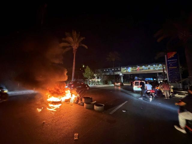 Hezbollah supporters block the old airport road in the southern suburbs of Beirut, with burning tires to protest against the trilateral agreement that was signed between the US, Israel and Lebanon on June 27, 2026. (Photo by Ibrahim AMRO / AFP)