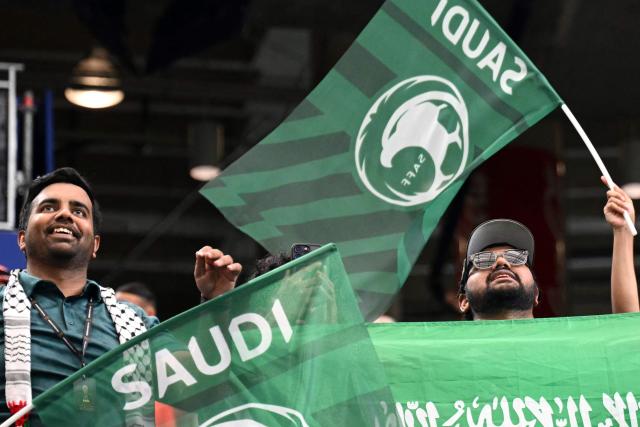 Saudi Arabia supporters wave flags ahead of the 2026 World Cup Group H football match between Cape Verde and Saudi Arabia at the Houston Stadium in Houston on June 26, 2026.  (Photo by RONALDO SCHEMIDT / AFP)