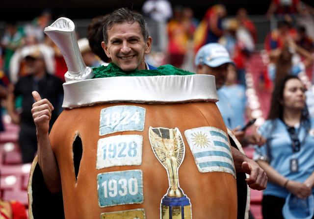 An Uruguayan fan wearing a coustume of a mate drink gestures ahead of the 2026 World Cup Group H football match between Uruguay and Spain at the Guadalajara Stadium in Zapopan on June 26, 2026.  (Photo by Ulises RUIZ / AFP)