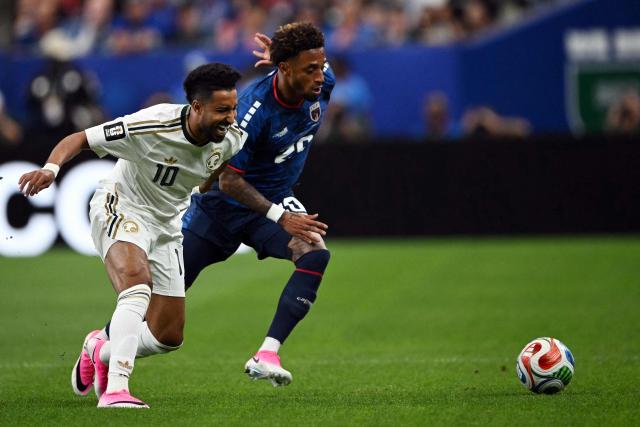 Saudi Arabia's forward #10 Salem Al-Dawsari (L) and Cape Verde's forward #20 Ryan Mendes compete for the ball during the 2026 World Cup Group H football match between Cape Verde and Saudi Arabia at the Houston Stadium in Houston on June 26, 2026.  (Photo by RONALDO SCHEMIDT / AFP)