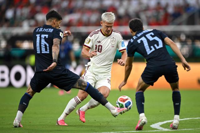 Uruguay's defender #16 Mathias Olivera, Spain's forward #10 Dani Olmo and Uruguay's midfielder #25 Juan Manuel Sanabria fight for the ball during the 2026 World Cup Group H football match between Uruguay and Spain at the Guadalajara Stadium in Zapopan on June 26, 2026.  (Photo by CARL DE SOUZA / AFP)
