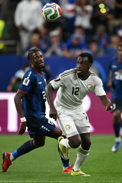 Saudi Arabia's defender #12 Saud Abdulhamid (R) runs with the ball during the 2026 World Cup Group H football match between Cape Verde and Saudi Arabia at the Houston Stadium in Houston on June 26, 2026.  (Photo by RONALDO SCHEMIDT / AFP)