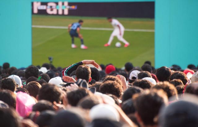 Fans watch the 2026 World Cup Group H football match between Uruguay and Spain on a giant screen at the FIFA Fan Festival, held at Plaza de la Liberacion and Plaza de Armas, in Guadalajara, Mexico, on June 26, 2026. (Photo by RUTH ROSAS / AFP)