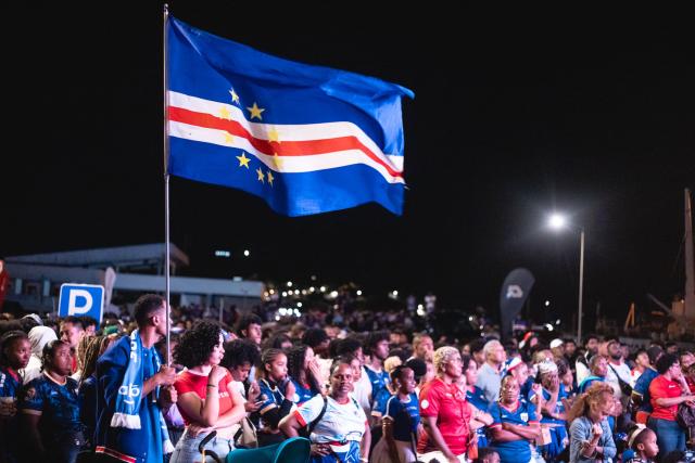 Supporters of Cape Verde's national football team wave a national flag as they watch the 2026 World Cup football tournament match between Cape Verde and Saudi Arabia in Mindelo, on June 27, 2026. (Photo by Queila Fernandes / AFP)