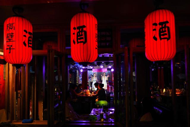Singers performs in a club in Chengdu, in China's southwestern Sichuan province on June 26, 2026. (Photo by HECTOR RETAMAL / AFP)