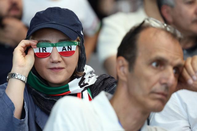 An Iran fan poses for a picture people watch the FIFA World Cup 2026 Group G football match between Egypt and Iran in Tehran on June 27, 2026. (Photo by AFP) / 