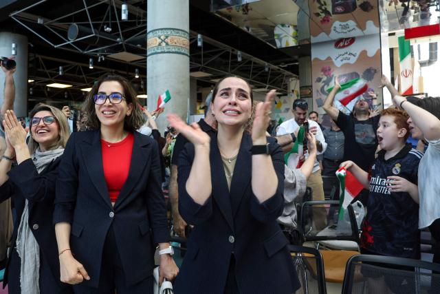 Iranians react as they watch the FIFA World Cup 2026 Group G football match between Egypt and Iran in Tehran on June 27, 2026. (Photo by AFP) / 