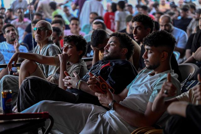 Egyptian football fans react as they watch their national team's 2026 World Cup Group G football match against Iran, at an outdoor cafe in the Sharabiya district of Cairo on June 27, 2026. (Photo by Khaled DESOUKI / AFP)