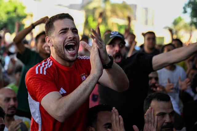 Egyptian football fans react as they watch their national team's 2026 World Cup Group G football match against Iran, at an outdoor cafe in the Sharabiya district of Cairo on June 27, 2026. (Photo by Khaled DESOUKI / AFP)