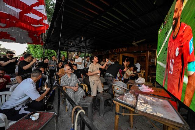 Egyptian football fans react as they watch their national team's 2026 World Cup Group G football match against Iran, at an outdoor cafe in the Sharabiya district of Cairo on June 27, 2026. (Photo by Khaled DESOUKI / AFP)