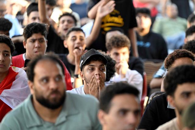 Egyptian football fans react as they watch their national team's 2026 World Cup Group G football match against Iran, at an outdoor cafe in the Sharabiya district of Cairo on June 27, 2026. (Photo by Khaled DESOUKI / AFP)
