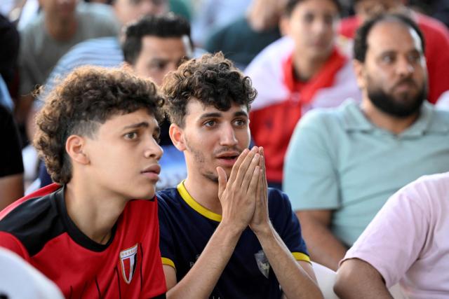 Egyptian football fans react as they watch their national team's 2026 World Cup Group G football match against Iran, at an outdoor cafe in the Sharabiya district of Cairo on June 27, 2026. (Photo by Khaled DESOUKI / AFP)