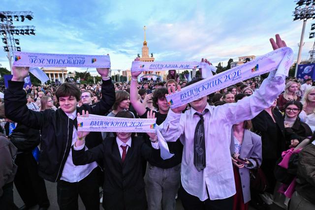High school graduates hold their graduation sashes during the Moscow Graduation Party at the All-Russia Exhibition Centre (VDNKh) in Moscow on June 26, 2026. (Photo by Igor IVANKO / AFP)