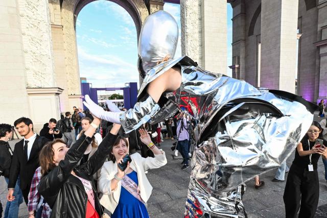 A performer welcomes graduates at the Moscow Graduation Party at the All-Russia Exhibition Centre (VDNKh) in Moscow on June 26, 2026. (Photo by Igor IVANKO / AFP)