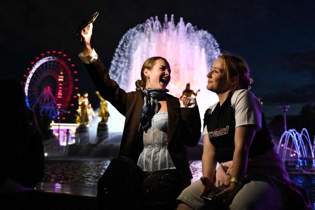 High school graduates pose for a selfie during the Moscow Graduation Party at the All-Russia Exhibition Centre (VDNKh) in Moscow on June 26, 2026. (Photo by Igor IVANKO / AFP)