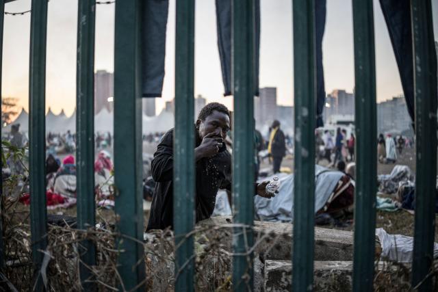 TOPSHOT - An undocumented migrant washes his face at the Durban Drive In in Durban, on June 27, 2026 where with others they will be registered by South African Immigration Officers ahead of their repatriation. Thousands of Malawians were awaiting clearance in makeshift encampments in South Africa Friday as tension mounted before an unofficial June 30 ultimatum for undocumented migrants to leave the country.
Citizen-led groups have rallied behind the unauthorised Tuesday deadline after weeks of protests, attacks on businesses and threats against illegal migrants in which two Mozambican nationals and a Malawian have been killed. (Photo by MARCO LONGARI / AFP)