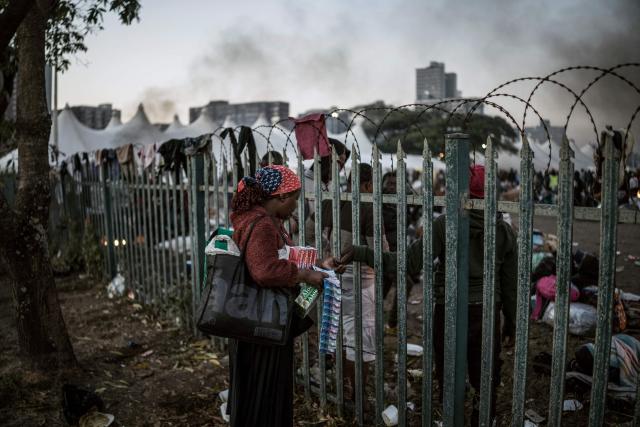 A vendor sell toiletry items to undocumented migrants at the Durban Drive In in Durban, on June 27, 2026 where they will be registered by South African Immigration Officers ahead of their repatriation. Thousands of Malawians were awaiting clearance in makeshift encampments in South Africa Friday as tension mounted before an unofficial June 30 ultimatum for undocumented migrants to leave the country.
Citizen-led groups have rallied behind the unauthorised Tuesday deadline after weeks of protests, attacks on businesses and threats against illegal migrants in which two Mozambican nationals and a Malawian have been killed. (Photo by MARCO LONGARI / AFP)