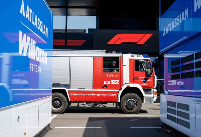 A firefighter waits in in a fire engine during a call in the paddock prior to the third practice session at the Red Bull Ring race track in Spielberg, Austria on June 27, 2026, ahead of the Formula One Austrian Grand Prix. (Photo by Joe KLAMAR / AFP)