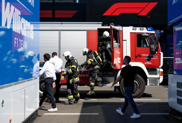 Firefighters get out of a fire-engine during a call in the paddock prior to the third practice session at the Red Bull Ring race track in Spielberg, Austria on June 27, 2026, ahead of the Formula One Austrian Grand Prix. (Photo by Joe KLAMAR / AFP)
