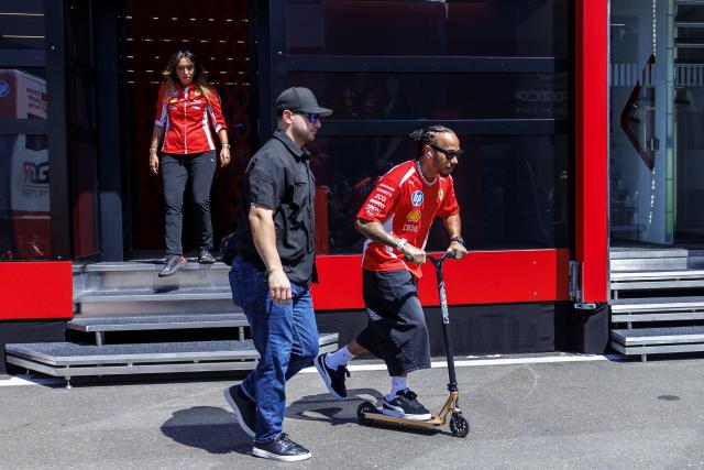 Ferrari's British driver Lewis Hamilton goes for a ride on his scooter in the paddock prior to the third practice session at the Red Bull Ring race track in Spielberg, Austria on June 27, 2026, ahead of the Formula One Austrian Grand Prix. (Photo by ERWIN SCHERIAU / APA / AFP) / Austria OUT