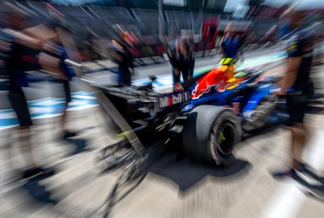 This slow shutter photograph taken with a zooming effect shows Red Bull Racing's French driver Isack Hadjar in the pit during the third practice session at the Red Bull Ring race track in Spielberg, Austria on June 27, 2026, ahead of the Formula One Austrian Grand Prix. (Photo by Joe KLAMAR / AFP)
