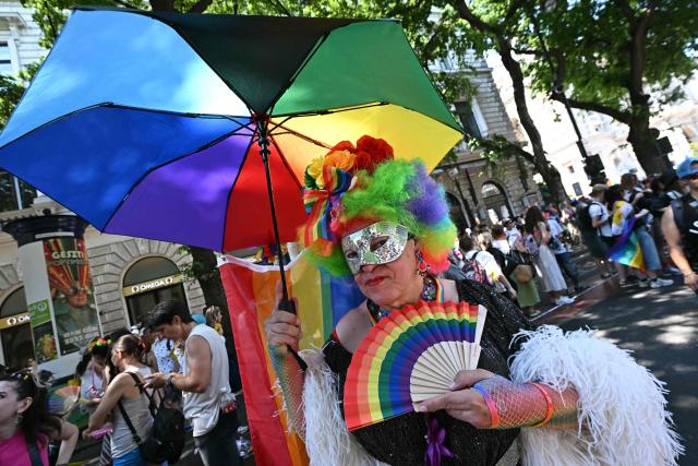 A participant poses for a picture as she gathers to the Budapest Pride Parade in Budapest, Hungary on June 27, 2026. (Photo by Attila KISBENEDEK / AFP)
