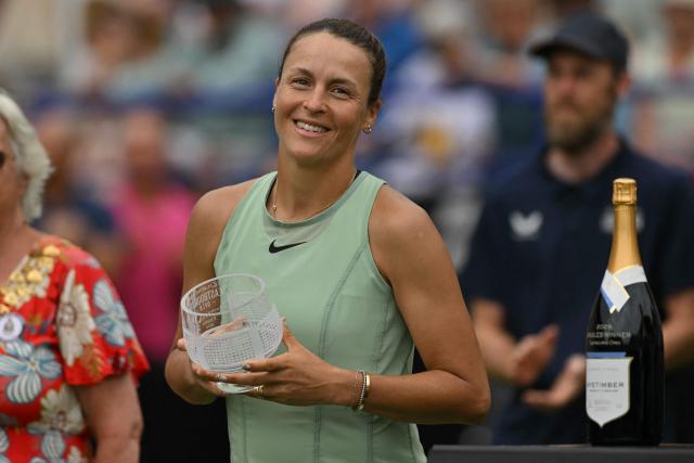 Germany's Tatjana Maria poses with her runners-up trophy after defeat to US player Madison Keys in their women's final tennis match on day six of the Lexus Eastbourne Open at Devonshire Park, Eastbourne, on the south coast of England on June 27, 2026. (Photo by Glyn KIRK / AFP)