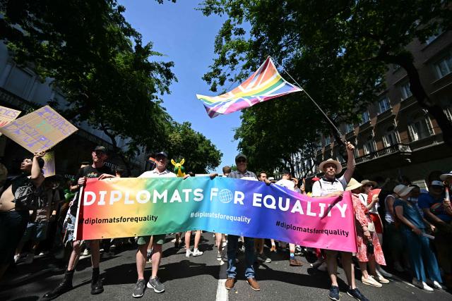 Participants hold a placard reading "Diplomats for equality" as people gather to the Budapest Pride Parade in Budapest, Hungary on June 27, 2026. (Photo by Attila KISBENEDEK / AFP)