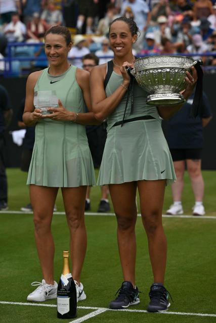 Winners, US player Madison Keys (R) and Germany's Tatjana Maria (L) pose with their trophies after their women's final tennis match on day six of the Lexus Eastbourne Open at Devonshire Park, Eastbourne, on the south coast of England on June 27, 2026. (Photo by Glyn KIRK / AFP)
