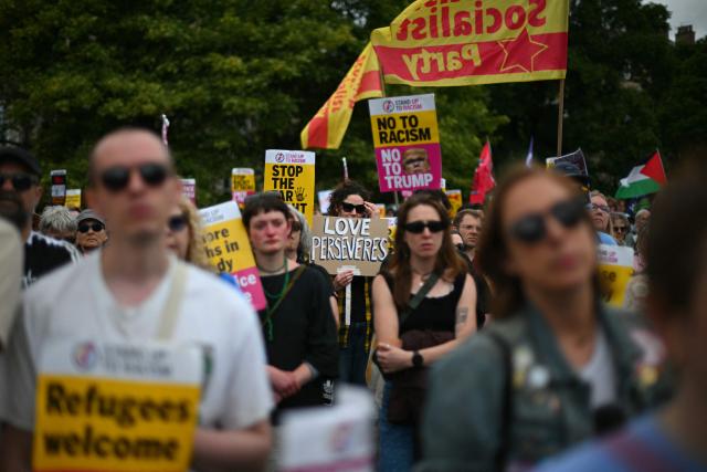 EDITORS NOTE: Graphic content / Protesters display banners as they take part in an anti-racism "Unity March and Rally", organised by Stand up to Racism, Scotland in Edinburgh on June 27, 2026. (Photo by ANDY BUCHANAN / AFP)