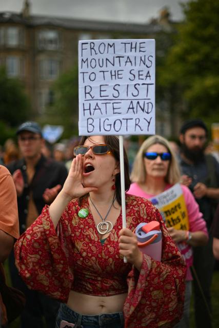 EDITORS NOTE: Graphic content / Protesters display banners as they take part in an anti-racism "Unity March and Rally", organised by Stand up to Racism, Scotland in Edinburgh on June 27, 2026. (Photo by ANDY BUCHANAN / AFP)