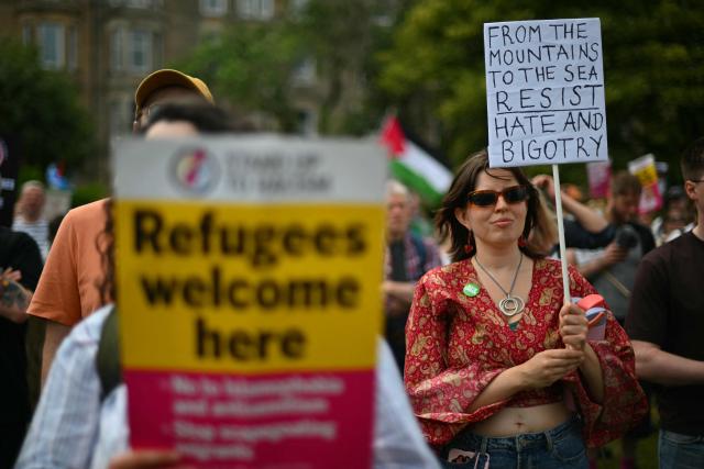 EDITORS NOTE: Graphic content / Protesters display banners as they take part in an anti-racism "Unity March and Rally", organised by Stand up to Racism, Scotland in Edinburgh on June 27, 2026. (Photo by ANDY BUCHANAN / AFP)