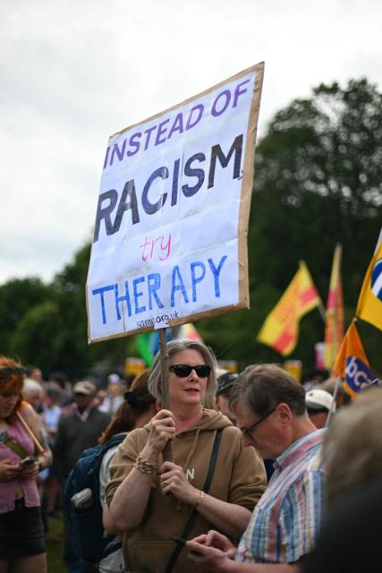 EDITORS NOTE: Graphic content / Protesters display banners as they take part in an anti-racism "Unity March and Rally", organised by Stand up to Racism, Scotland in Edinburgh on June 27, 2026. (Photo by ANDY BUCHANAN / AFP)