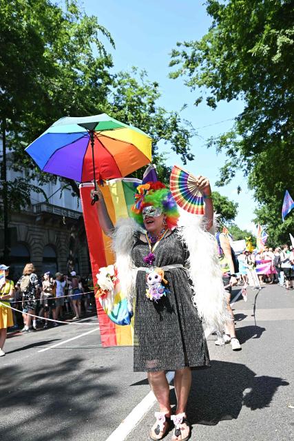 A participant poses for a picture as people gather to the Budapest Pride Parade in Budapest, Hungary on June 27, 2026. (Photo by Attila KISBENEDEK / AFP)
