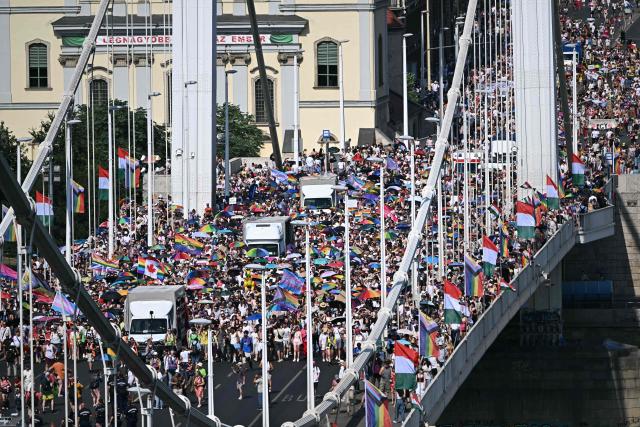 Participants march on the Elisabeth bridge as they take part in the Budapest Pride Parade in Budapest, Hungary on June 27, 2026. (Photo by Attila KISBENEDEK / AFP)